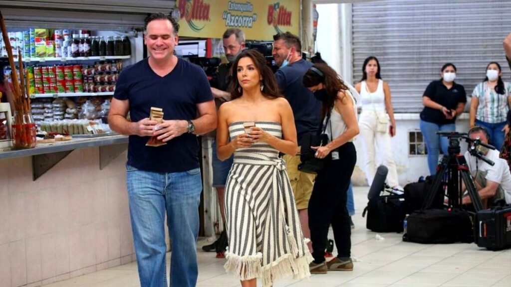 Chef Roberto Solis walking along side Eva Longoria at the Mercado de Santiago.